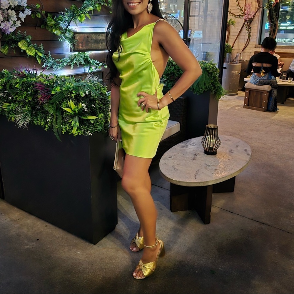 Revolve Khanum’s green satin dress with golden chain size M